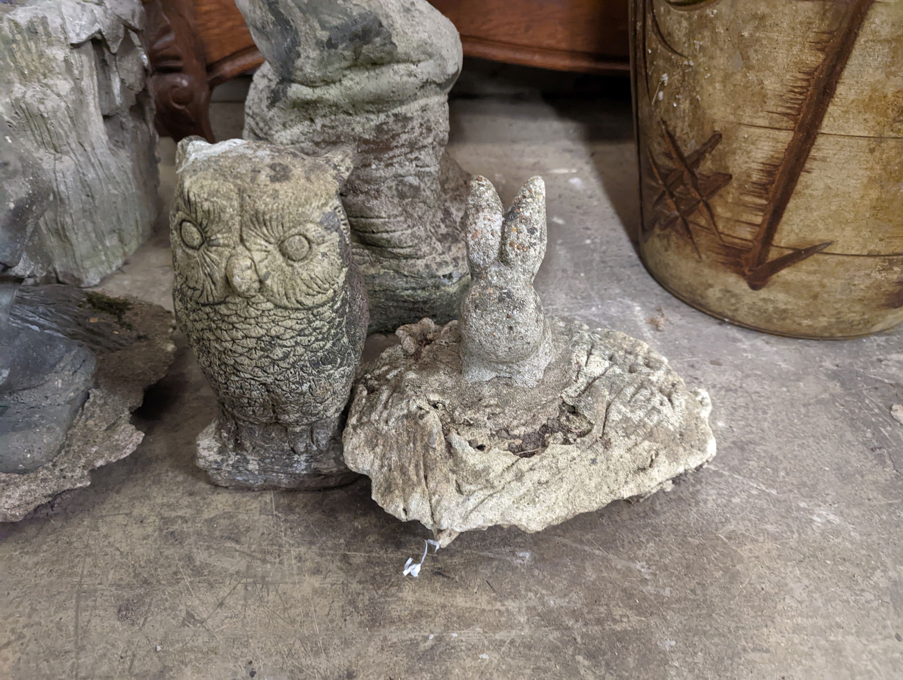 A reconstituted stone garden bird bath, height 59cm, together with four stone garden ornaments